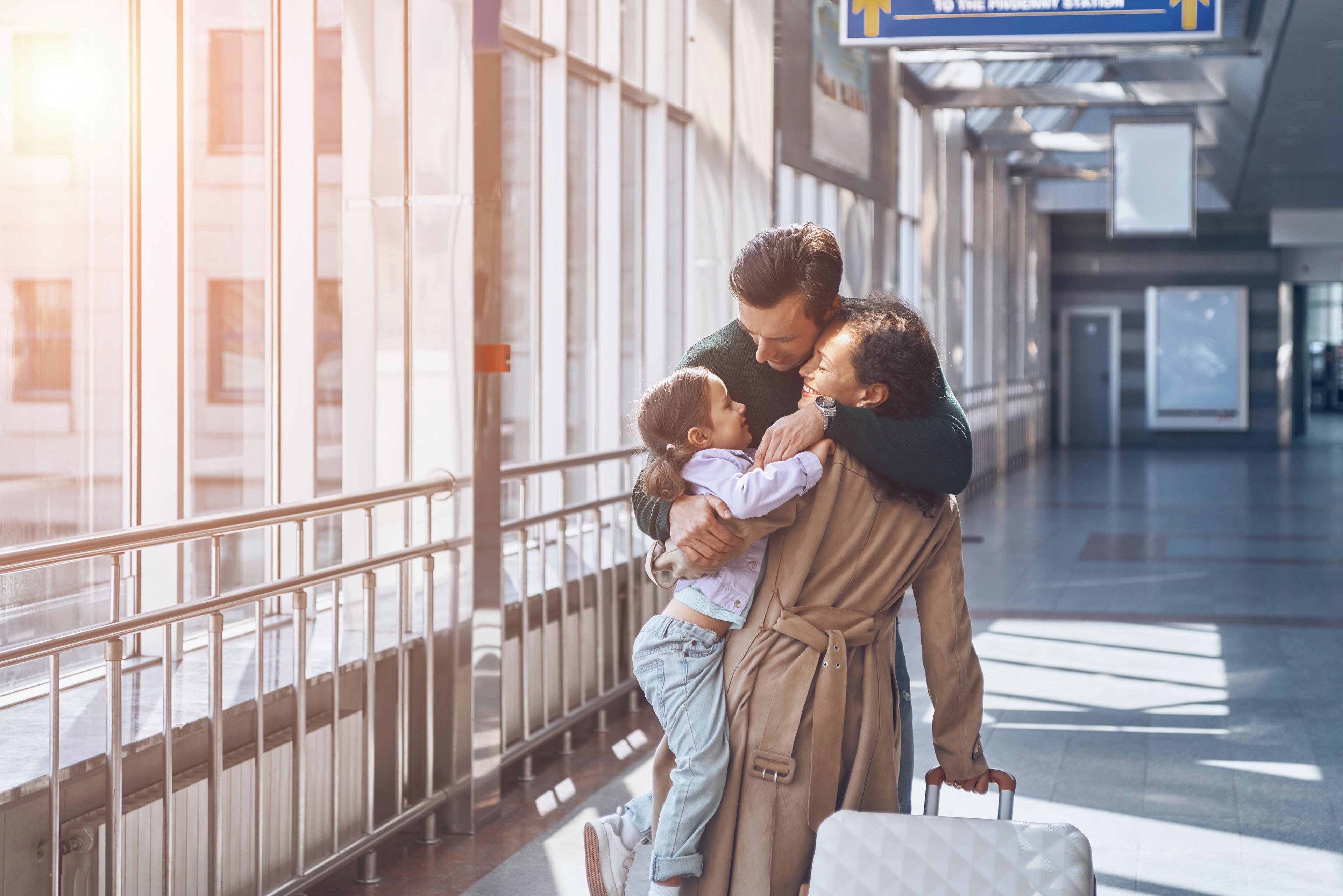 Passengers warmly greeting each other at an airport, symbolizing the positive and secure experience of air travel, thanks to the remarkable safety achievements in the aerospace industry